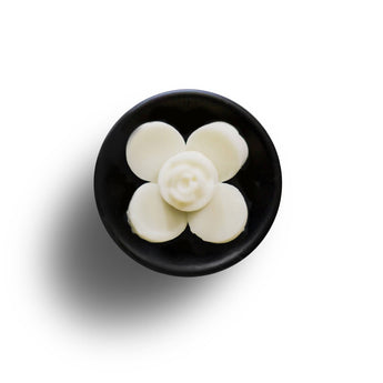 Freckleface Vanilla and Peony Soya Wax Melts in a clear container, showcasing creamy vanilla and delicate peony fragrance.
