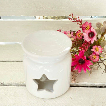 White star-shaped wax burner by Freckleface with a smooth ceramic finish, designed for melting scented wax melts.