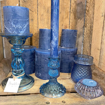 Blue glass Harlequin candle holder by Grand Illusions, featuring a geometric pattern and elegant design for decorative candle display.