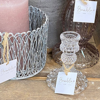 Clear glass candle holder with a harlequin pattern by Grand Illusions, designed to hold candles and add decorative elegance.