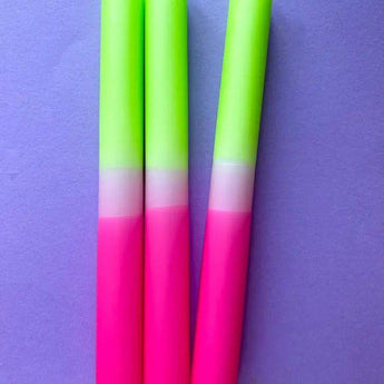 Set of three Colour Emporium dip dye glow stick dinner candles with vibrant, colorful patterns on each candle.