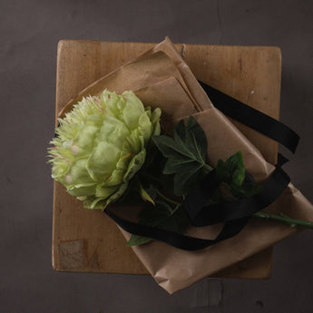 Artificial green peony faux flower stem from Hills Interiors, showcasing vibrant, realistic green peony blooms on a single stem.
