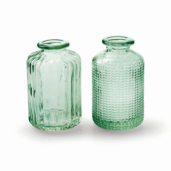 Green glass bottle vase with vertical pattern by Casa Verde, showcasing a sleek, modern design ideal for floral arrangements.