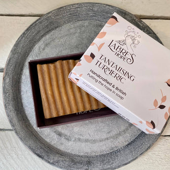 Labre's Hope Tantalising Turmeric Soap with bright yellow color and natural turmeric ingredients, showcasing a refreshing skincare product.