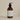 Plum & Ashby Neroli & Bergamot Hand & Body Wash in a clear bottle with a floral and citrus scent, displayed with fresh ingredients.