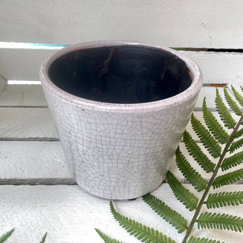 Six old-style Dutch pots in assorted vibrant colors, featuring traditional design by Grand Illusions.