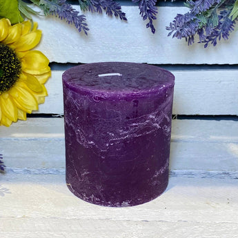 Rustic amethyst pillar candle by Grand Illusions, 100x100mm, showcasing a textured purple candle with a natural, rustic finish.