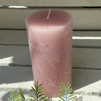 Rustic dusky pink pillar candle from Grand Illusions, 70x130mm, with textured surface and warm, inviting glow.
