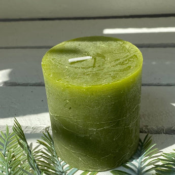 Fern green rustic pillar candle by Grand Illusions, 70x75mm, with textured wax surface and natural candle shape.