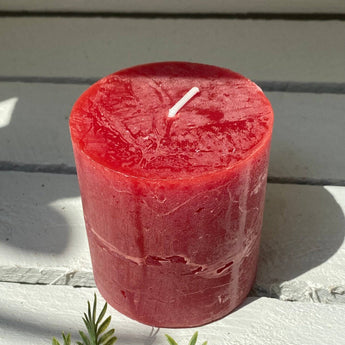 Rustic Lipstick Red Pillar Candle by Grand Illusions, 70x75mm, with textured rustic finish and warm candlelight glow.