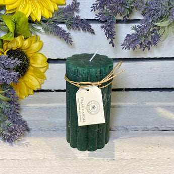 Emerald green rustic scalloped pillar candle by Grand Illusions, 70x130mm, showcasing textured design and warm candlelight glow.