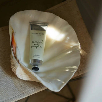 Seaweed and samphire hand cream by Plum & Ashby, featuring a creamy texture in a sleek tube for nourishing skin.