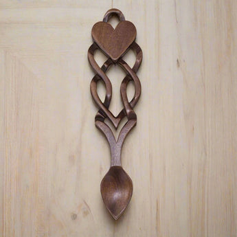 Welsh Love Spoon by Cadwyn Ltd featuring intricate wood carvings symbolizing good luck and togetherness.